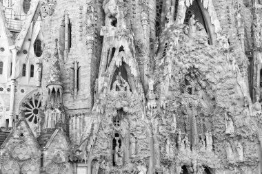 Architectural detail of Nativity facade with sculptures of Sagrada Familia gothic cathedral church building in Barcelona, Spain.