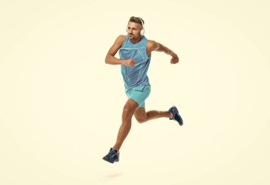 The jogger stretched body before running. sport jogger listen to music in headphones. The jogger ran at sport training isolated on white. In a morning sport workout jogger run in studio. clipart