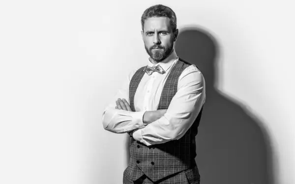 stock image tuxedo man in studio with copy space. photo of man wearing tuxedo. man wear tuxedo formal suit. man in tuxedo on grey background.