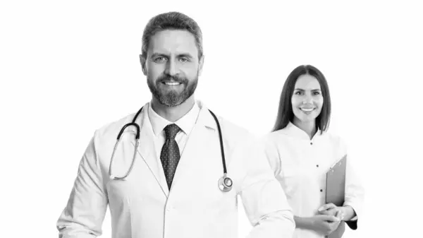 stock image selective focus of doctor and nurse wear white coat. nurse and doctor with laptop and anamnesis. doctor and nurse isolated on white background. doctor with nurse in studio.