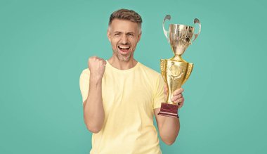 successful champion man celebrate victory with award in studio. champion man celebrate award victory. photo of champion man celebrate victory with award. champion man celebrate victory award