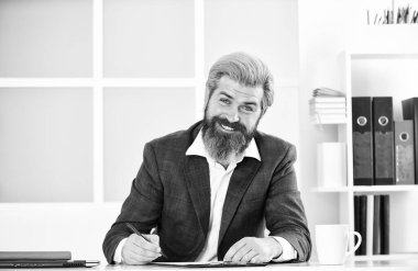 Quarantine during viral infection. Portrait of bearded man sitting at desk in office. confident brutal businessman. Elegant businessman analyzing data in office. Professional Office Corporate.