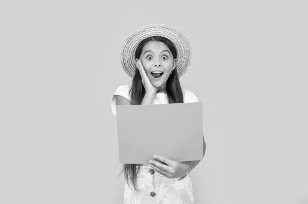 stock image surprised teen girl with copy space on orange paper on yellow background.