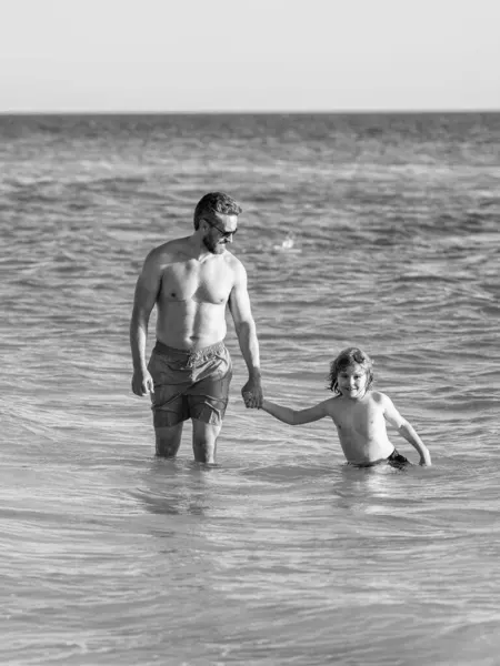 stock image dad and son child has special moments at sea. Father son adventures. dad man and son kid running in sea beach. Father son bonding enjoying summer vacation. Bonding activities.