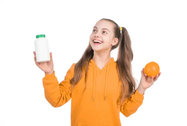 stock image happy kid choose between orange fruit and vitamin pill in jar bottle isolated on white, medicine.