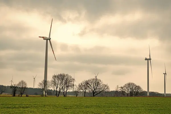 stock image Alternative renewable energy generation. green energy concept. Wind mill for renewable electric energy production. Windmill in a rural area. offshore wind park. Wind Turbines innovation.