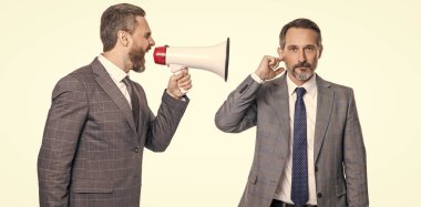 businessmen ignore shouting in megaphone isolated. businessmen ignore shouting in megaphone at studio. businessmen ignore shouting in megaphone. two businessmen ignore shouting in megaphone.