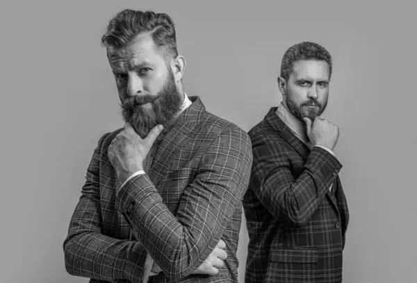 stock image caucasian men in tuxedo menswear at studio. men in tuxedo menswear on background. photo of men in tuxedo menswear suits. men in tuxedo menswear isolated on grey.