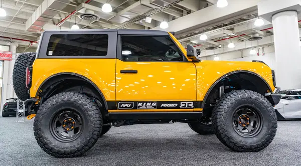 stock image New York City, USA - March 27, 2024: Ford Bronco 2020 yellow vehicle at New York International Auto Show, side view.