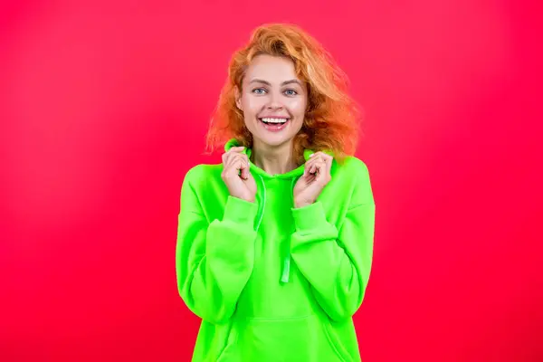 stock image Stylish Caucasian woman or redhead girl fashion model in casual stylish and trendy hoodie bright color isolated on pink.