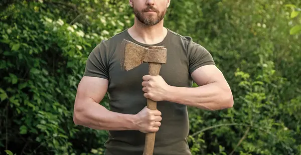 stock image cropped view of man with ax wearing shirt. man with ax outdoor. photo of man with ax. man with ax.