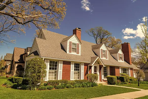 stock image modern cottage house. architecture concept. property in neighborhood. real estate and property insurance. property and architecture. housing. suburban house architecture. residential building.