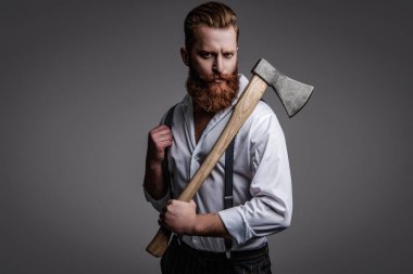 Saç ve sakal bakımı. Yakışıklı, sakallı, vahşi adam. Sakal şekillendirme. Bıyıklı, Kafkas bir hippi. Sakallı adam gri yolda izole edilmiş. Sakallı adam, baltayı tut. Modern berber dükkanı.