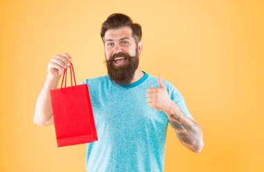 new collection. happy hipster hold paperbag. Man with gift package. Buy product. little pleasantness. bearded man go shopping. mall for men. mature male beard with fashion purchase. clipart