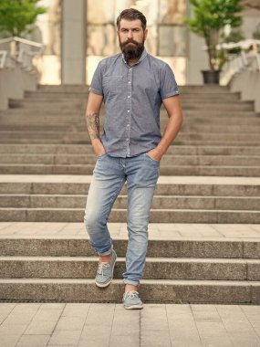 bearded man walk downstairs. full length of man with beard. hipster man outdoor.