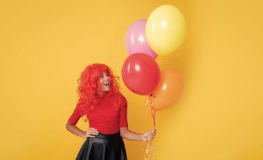 sarı arka planda parti balonu olan sürpriz çocuk.