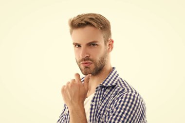 Karizmatik, tıraşsız, kareli gömlekli adam. Tıraşsız erkek derisi. Traşsız adamın stüdyo çekimi. Genç traşsız adam beyaz arka planda izole edilmiş..