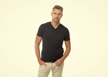 Boz adamın stüdyo çekimi. Beyaz arka planda izole edilmiş olgun, kır saçlı bir adam. Gri tişörtlü, kır saçlı adam. Boz adam tarzı..