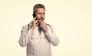 man doctor talking on phone isolated on white. doctor online consultation. doctor helpline. clipart