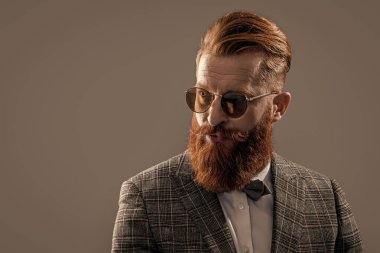 bearded tuxedo formal man in studio. tuxedo formal man on background. photo of tuxedo formal man with beard. tuxedo formal man isolated on grey.