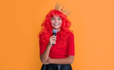 glad kid in crown with microphone on yellow background.