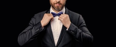 Stüdyoda smokin giyen adamın resmi görüntüsü. Resmi papyonlu smokinli adam. Resmi takım elbiseli smokinli adamın fotoğrafı. resmi smokin adam siyah arkaplanda izole.