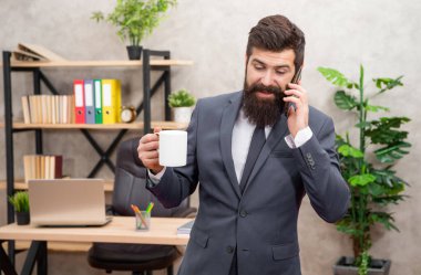 Business phone call. Businessman being on cellphone while drinking coffee. Making phone call. Mobile communication. Keep you sounding professional.