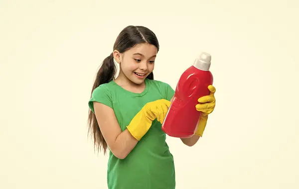 stock image smiling girl with laundry detergent on background. photo of girl with laundry detergent. girl with laundry detergent isolated on white. girl with laundry detergent in studio.