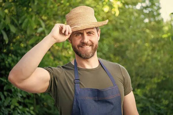 stock image Happy farmer man tipping farmers hat and smiling natural outdoors.