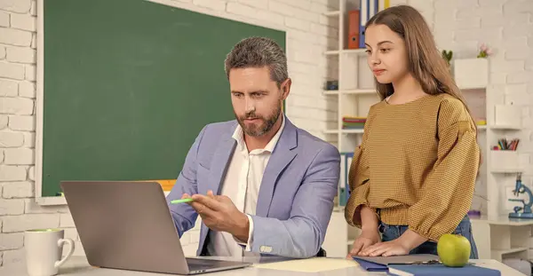 stock image curious teen girl with man teacher in classroom. education.