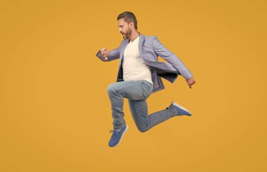 man rushing isolated on yellow studio background. man hurry to meet deadline. concept of deadline.