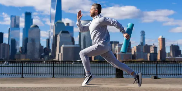 stock image Sportsman jogger running. Sport runner in Manhattan. The sportsman running at view to New York. Man sportsman running for exercise in active wear. Advertisement.