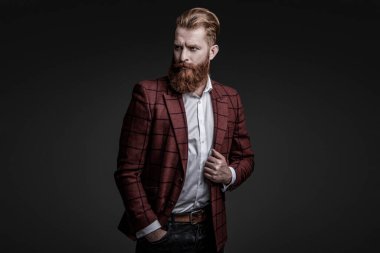 Erkek giyim kuşamı. Bespoke takımı. Özel dikim erkek giysisi giymiş sakallı adam. Özel dikim kıyafet giyen bir iş adamı. Şık takım elbiseli bir iş adamı. Resmi terzilik kıyafeti. Klasik biçim.