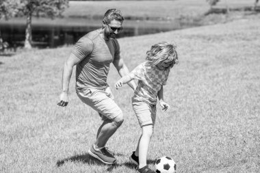 football family team of father and son. soccer activity. Fatherhood in outdoor of daddy and son kid. daddy with son improve fatherhood. Outdoor adventures of daddy and son fatherhood together. clipart