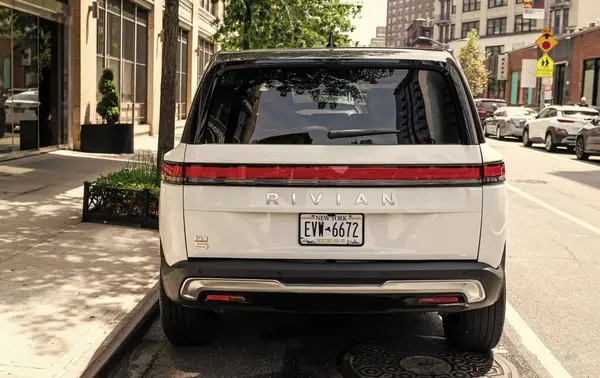 stock image New York City, USA - August 06, 2023: Rivian R1S SUV white electric car rear view, parked.