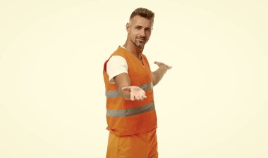 man supervisor presenting in studio. man supervisor on background. photo of man supervisor wear orange waistcoat. man supervisor isolated on white.