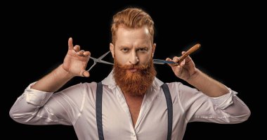 barber man isolated in black. barber man in studio. barber man with scissors and retro razor blade. photo of barber man on background.