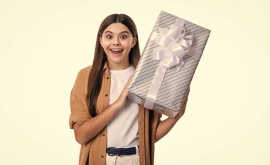 amazed teen girl with birthday gift box. photo of teen girl hold birthday gift. teen girl with birthday gift isolated on white background. teen girl holding birthday gift in studio. clipart