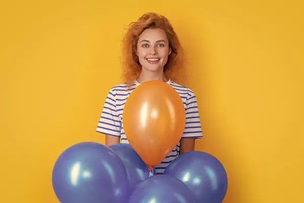 stock image glad woman hold party balloons in studio. woman with balloon for party isolated on yellow background. party woman with balloon.