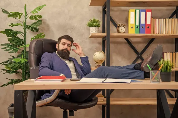 stock image If youre tired, learn to rest. Tired businessman relaxing in desk chair. Work break in office. You are enough, relax.