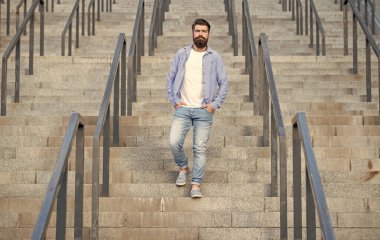 Sakallı adam aşağı iniyor. Sakallı bir adam. Hipster adam merdivenlerden aşağı in..