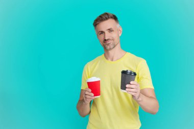 Yaşam tarzı konsepti. Kafeinsiz içiyorum. Çay içen adam. Sıcak bir sabah, rahatla. Kahveci adamla kahve molası. Olgun bir adam mavi üzerine kafeinsiz kahve fincanı seçer. Sabah kahvesi vakti. Pankart.