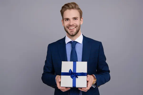 stock image Mens day. Successful boss share gift box. Businessman prepare for romance date. Business reward. Business man with corporate gift box isolated on grey. Corporate present. Business souvenir.