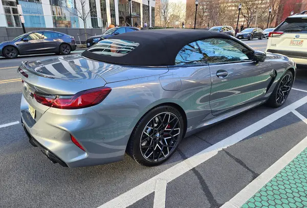 stock image New York City, USA - March 11, 2024: BMW M8 convertible luxury solver car parked outdoor, back side view.