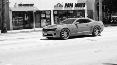 Miami Beach, Florida USA - April 15, 2021: orange Chevrolet Camaro SS 2019 muscle car, side view.