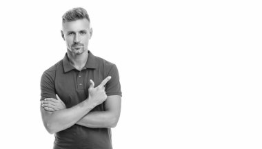 Beyaz arka planda, kırmızı tişörtlü, kır saçlı yakışıklı bir adam. işaret parmağı.