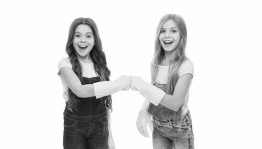 Lets start cleaning. Kids cleaning together. Girls with yellow rubber protective gloves ready for cleaning. Household duties. Little helper. Girls cute kids love cleaning around. Keep it clean.