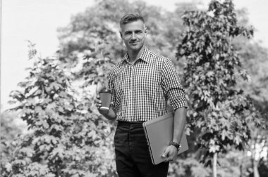 happy man with coffee. man freelancer drink coffee outdoor. business man has coffee break.