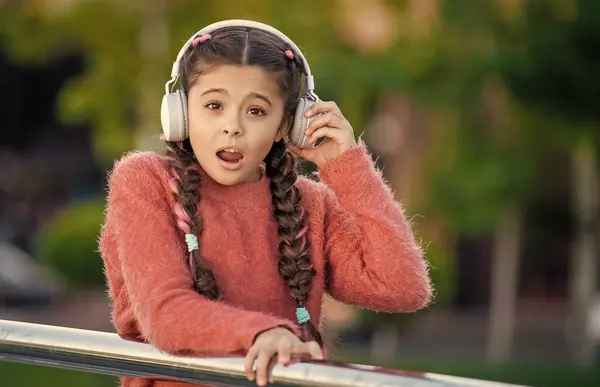 Stock image Teen girl cant hear well because of music. Teenager taking off headphones for music. Listening to music not hearing what someone says.