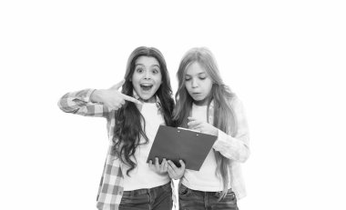 After examination. Excited children checking up examination result in clipboard. Little girls holding examination pad. Taking writing test and examination.